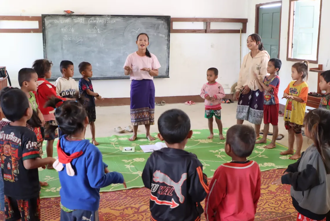 Pheng and Laithong with their students doing a rhythm and dance activity in class to promote coordination and creativity. 