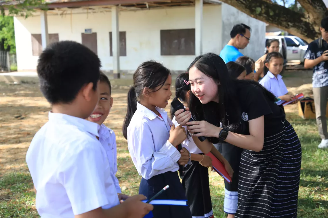 Chan doing a environmental awareness activity with school children. 