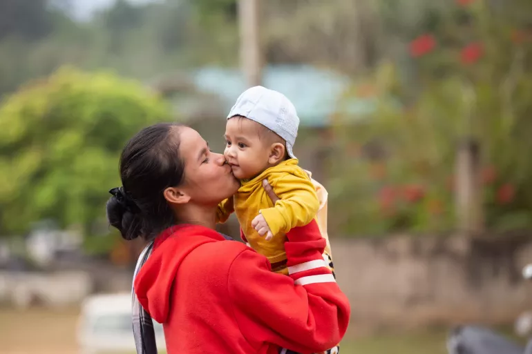 Mother holding her child.