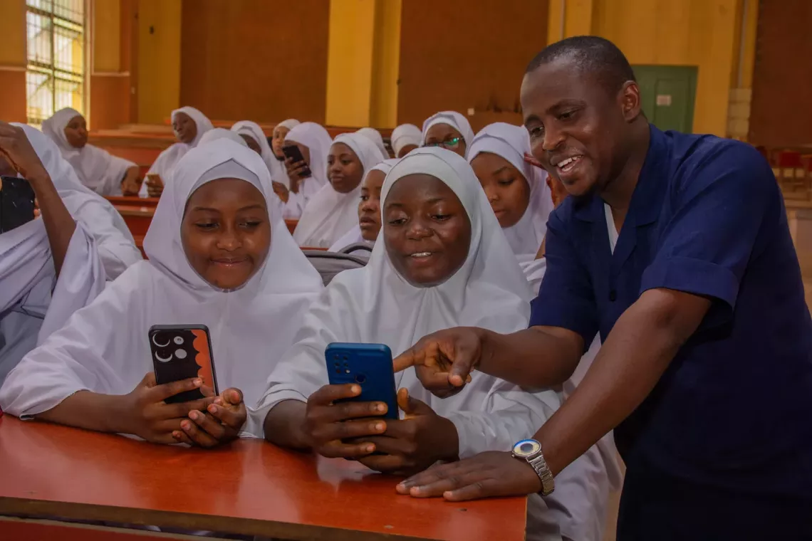 2 girls using the Learning Passport with a facilitator