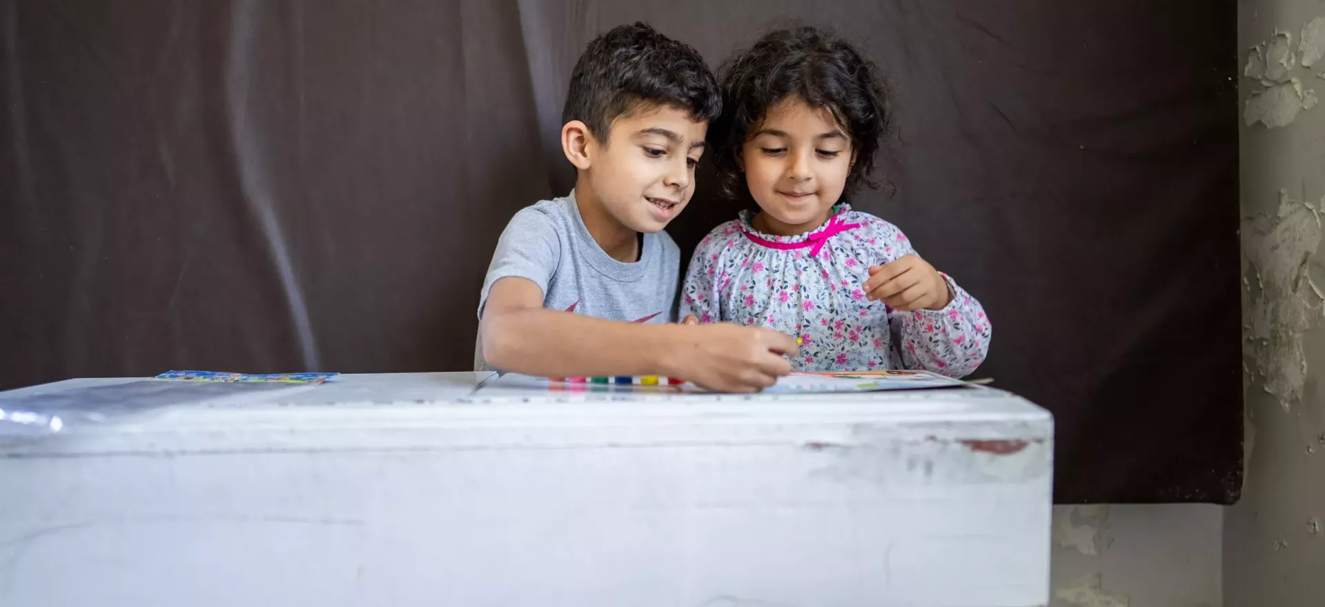 Ahmad 7 years odl and his sister nour, 4 at a school shelter