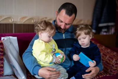 Jinane and Layane, 1 year old. with their father