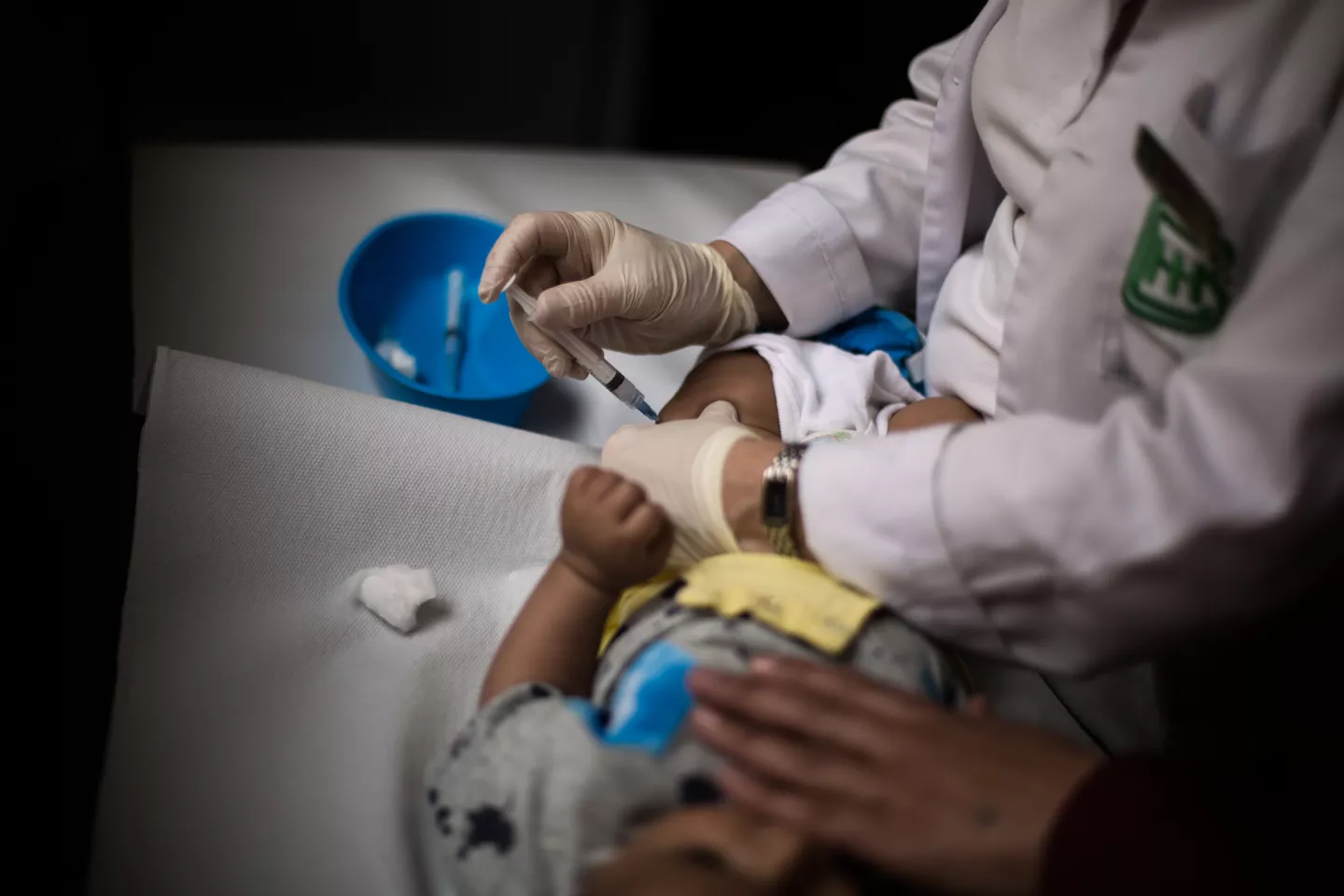 A baby is getting a vaccine in a primary health care center in Beirut
