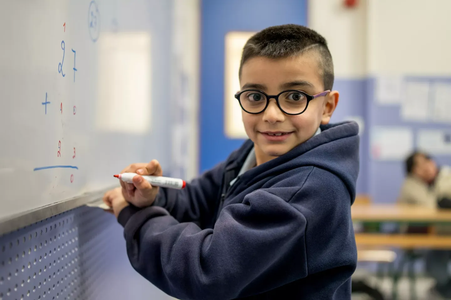 A child with disability smiling in the classroom 