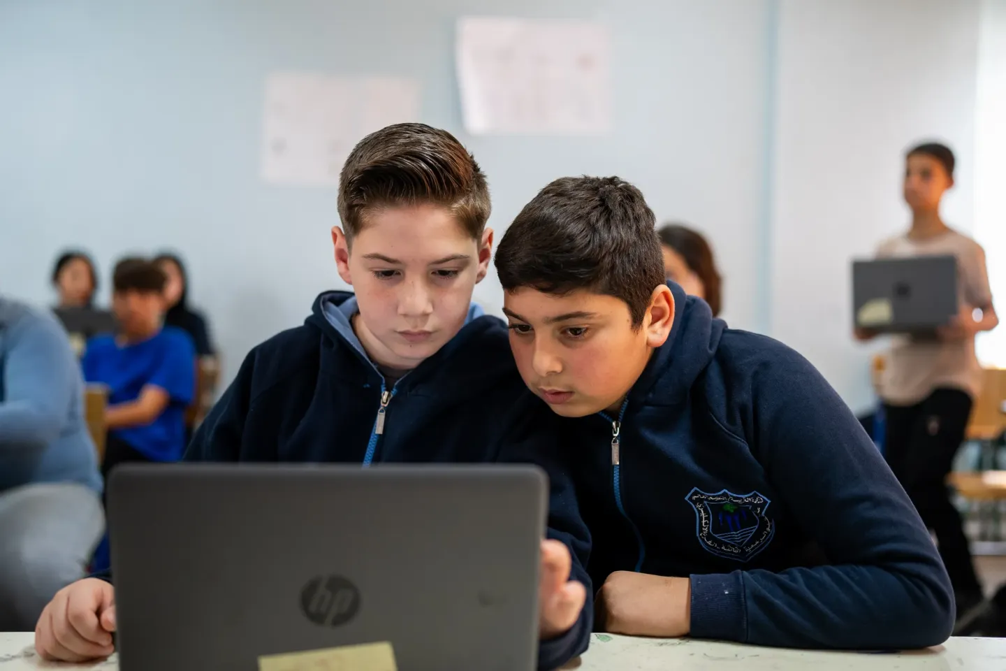 Two students looking at the computer during a digital learning class 