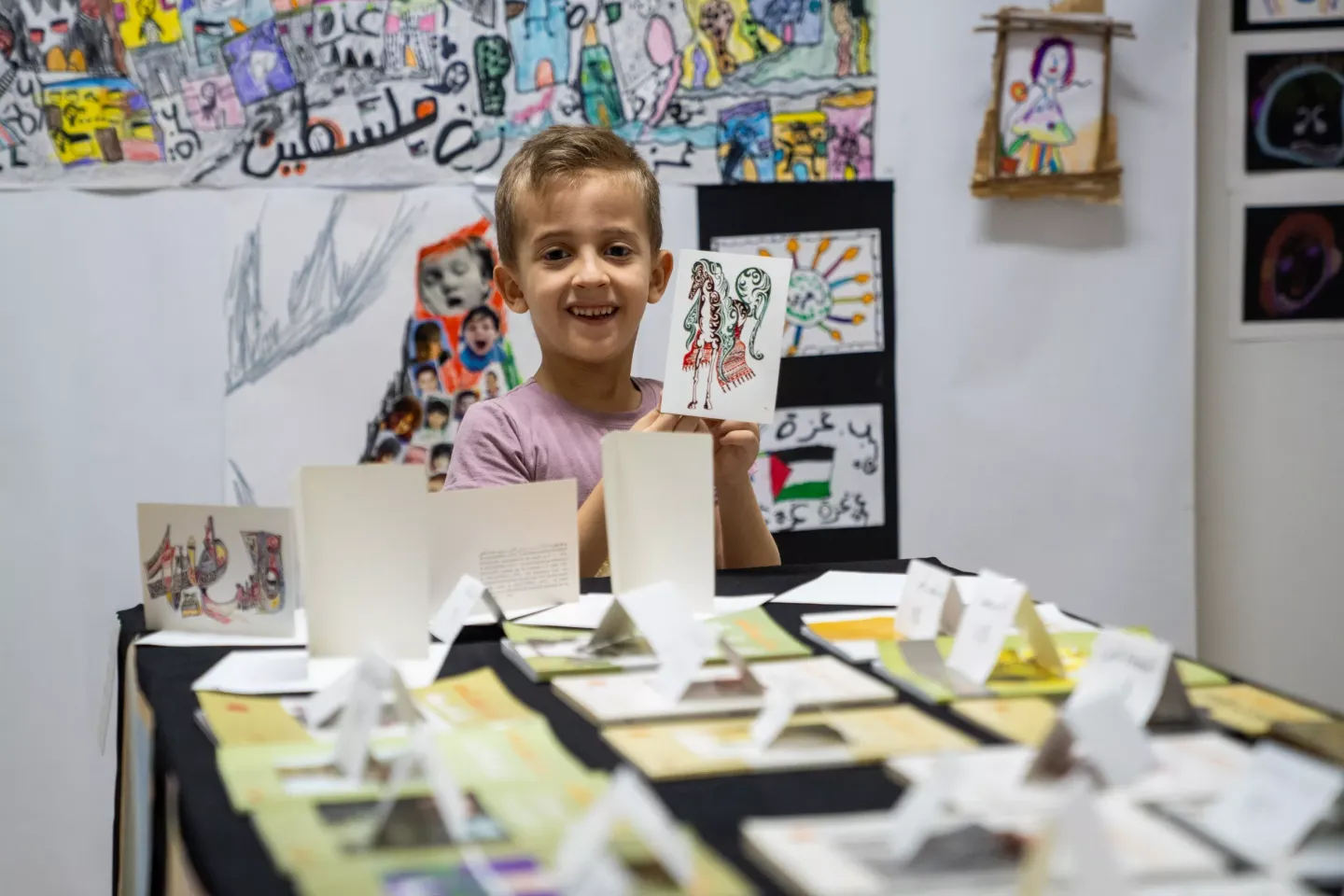A child holding a drawing