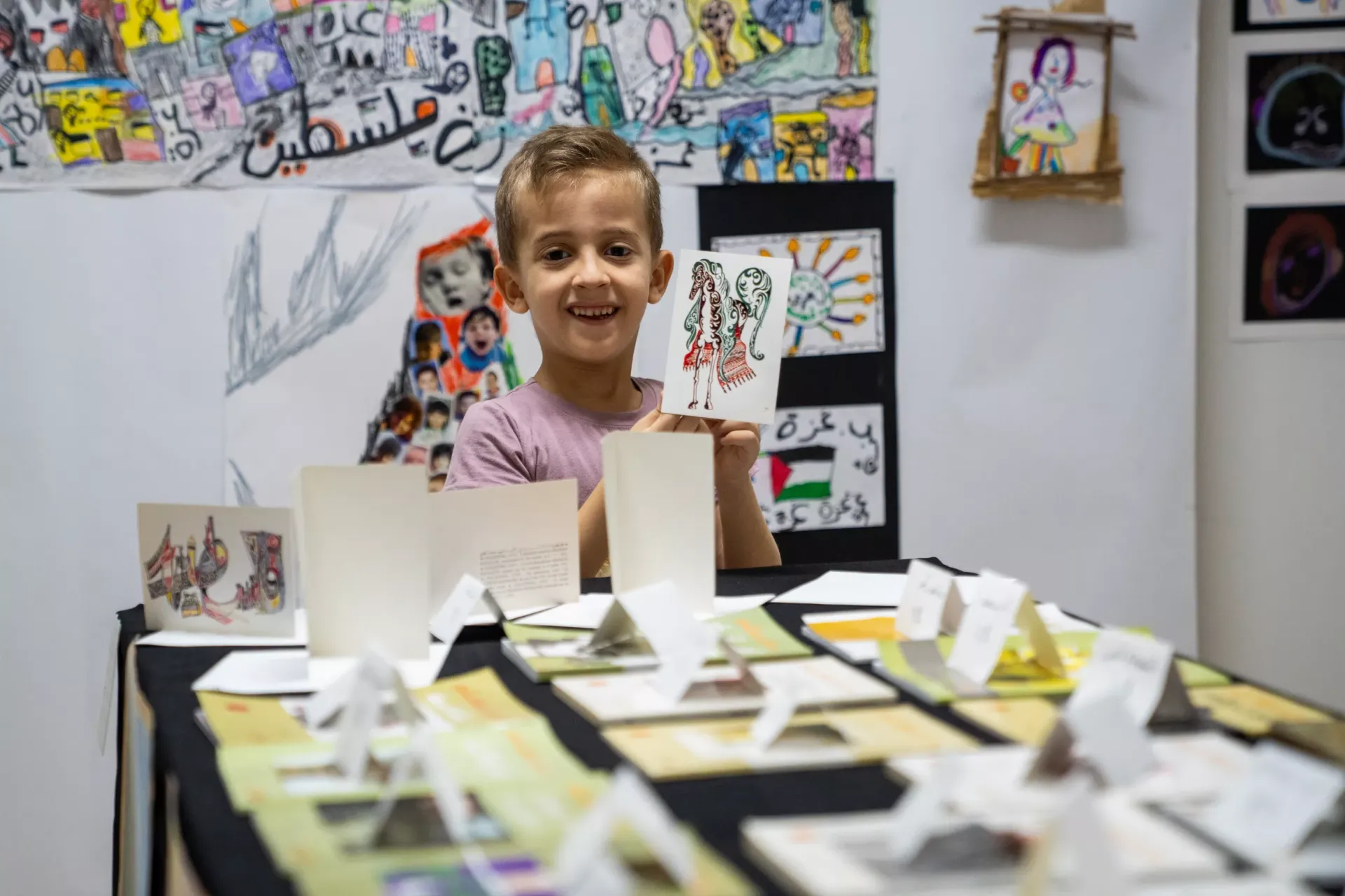 A child holding a drawing