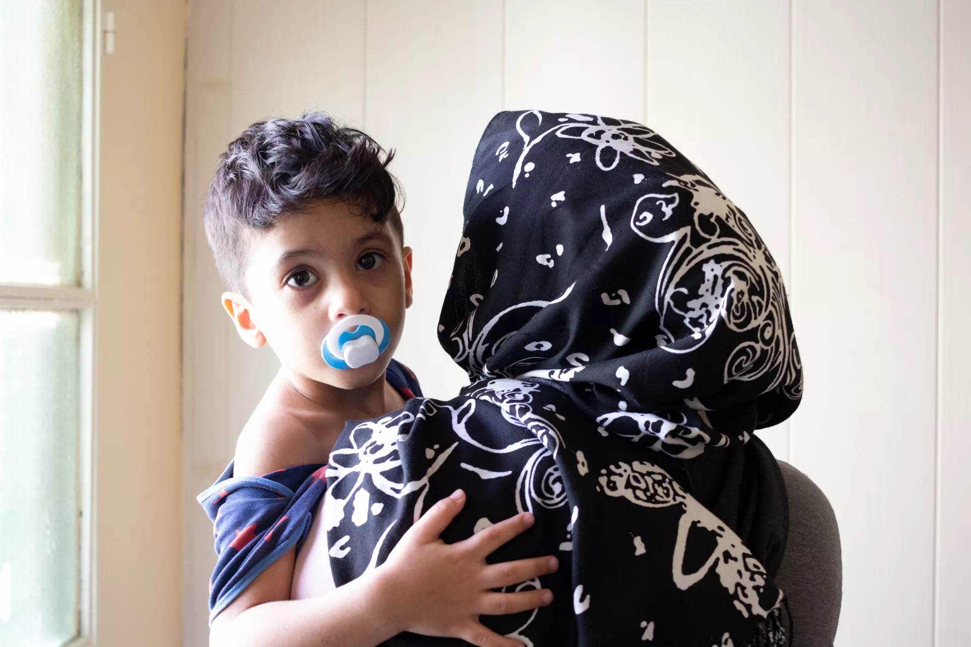 Nadia, holding her five-year-old son Ahmad