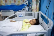 Amir, 8, injured at the hospital bed