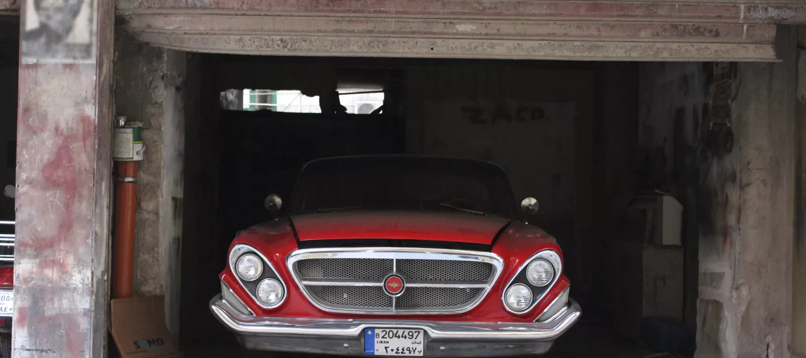 Photo of an old car in garage taken by one of the refugees youth