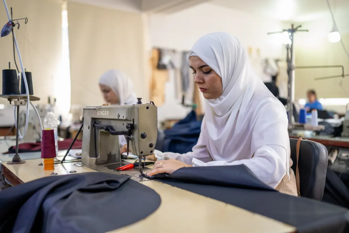 Nada Olayane CBT Participant sewing winter kits 