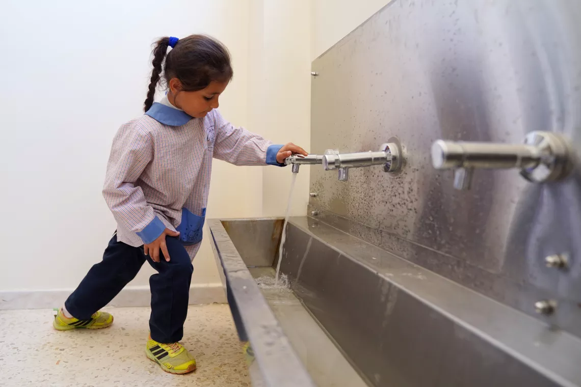 A small girl washing her hands 