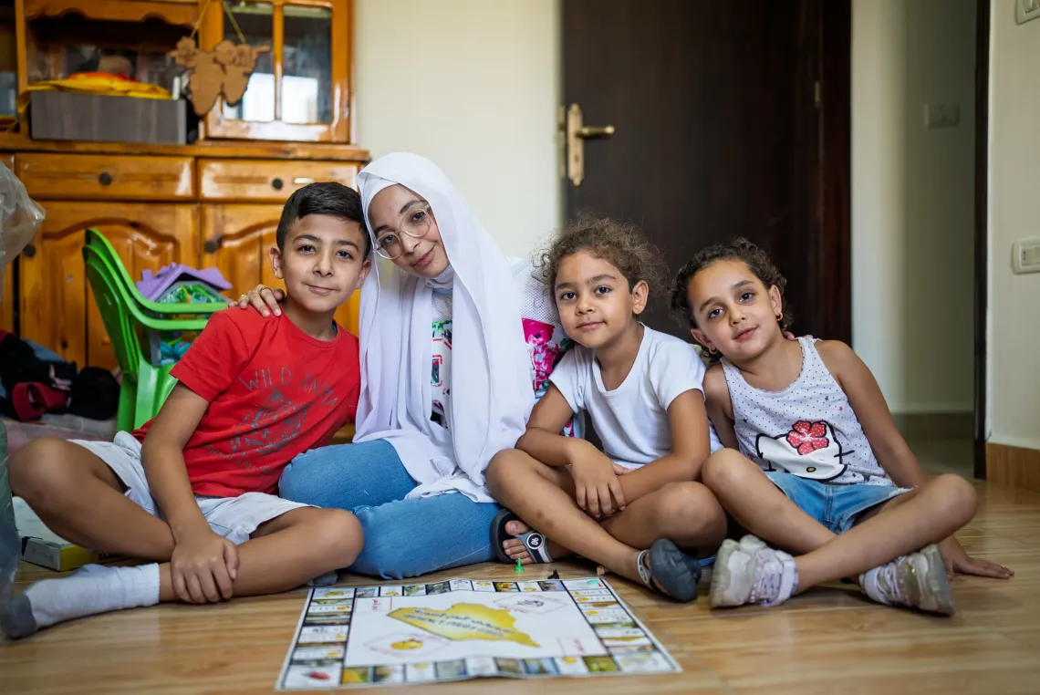 Children sitting next to each others playing board games 
