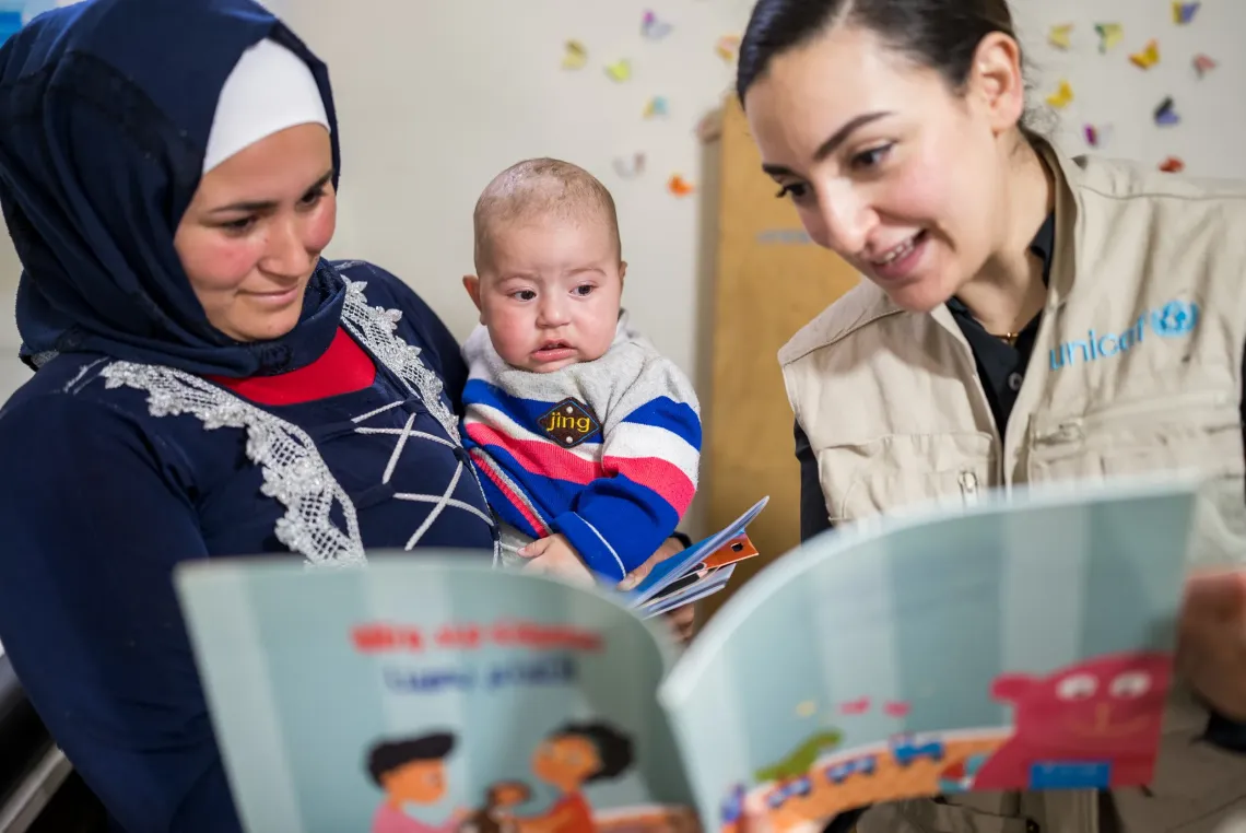Bader, 9 month old with his mother and UNICEF Heath Officer.