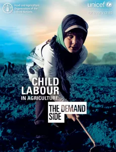 A child is plowing the field during daytime.
