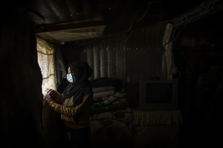 Rahaf, 15 years old at her family tent 