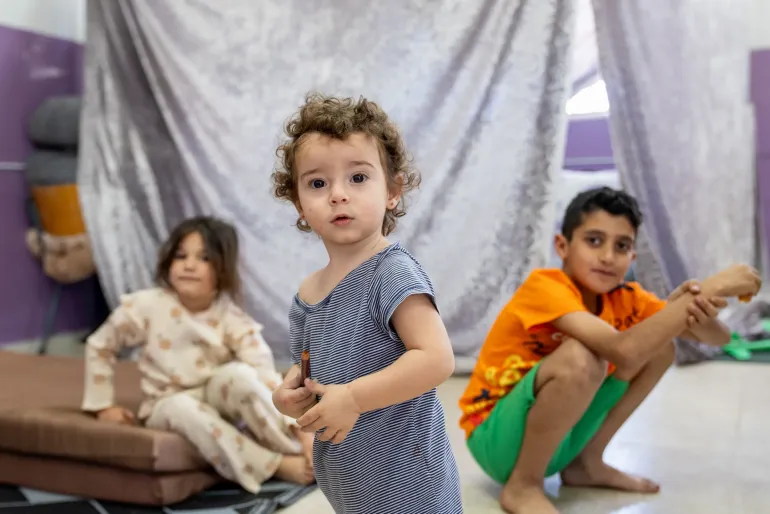 Children sitting in a school shelter 