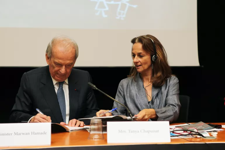 Minister Hamadeh and Tanya Chapuisat signing the Policy book