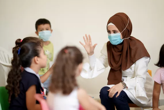 Haneen playing with children