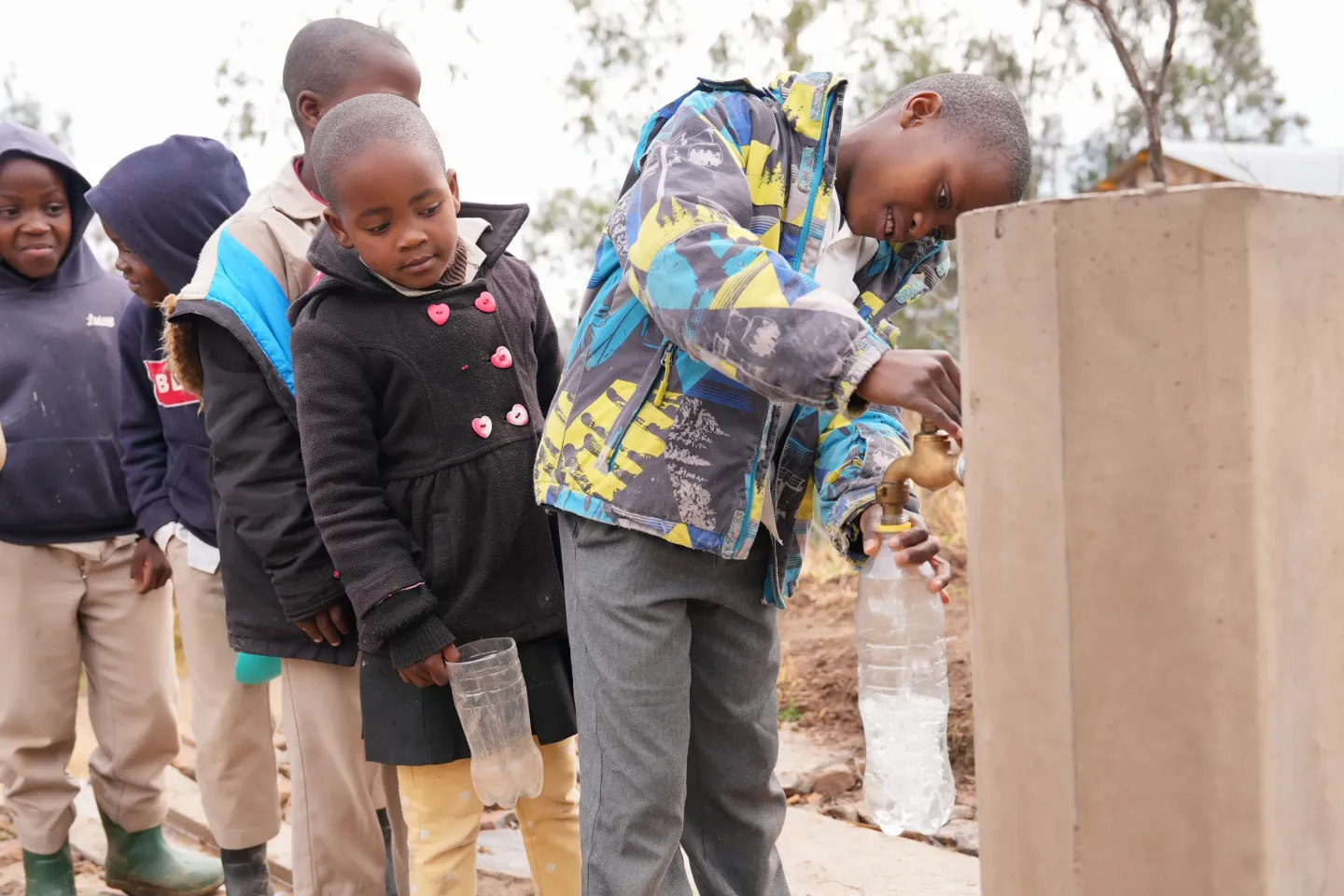 Learners at Qhalasi Primary School in Quthing, queue up to get drinking water from the newly installed tap