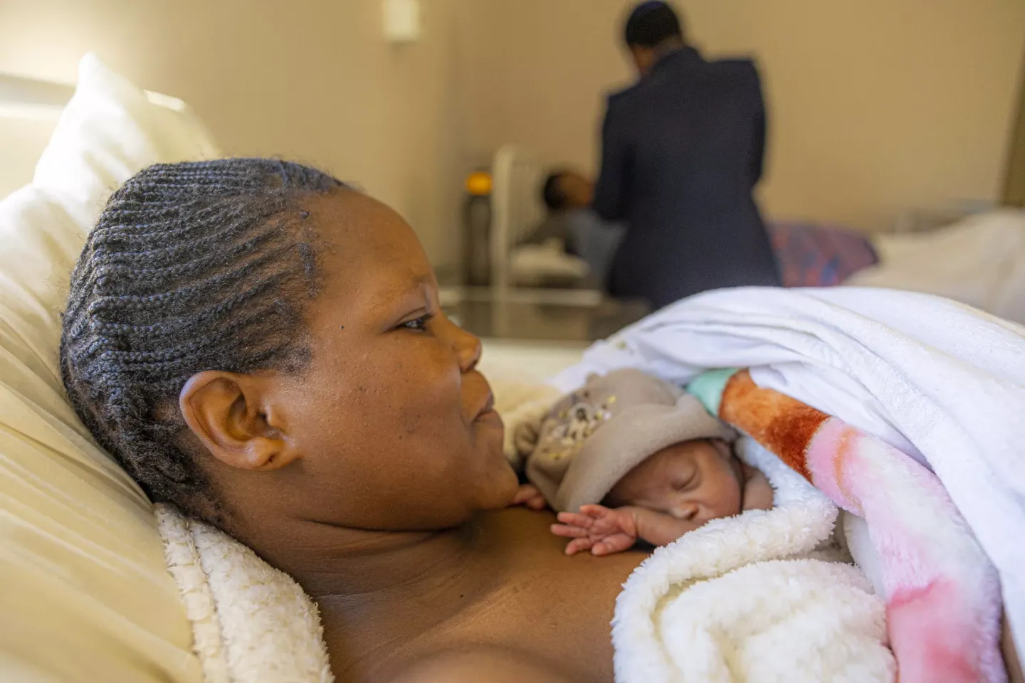 A mother holds her newborn baby skin-to-skin