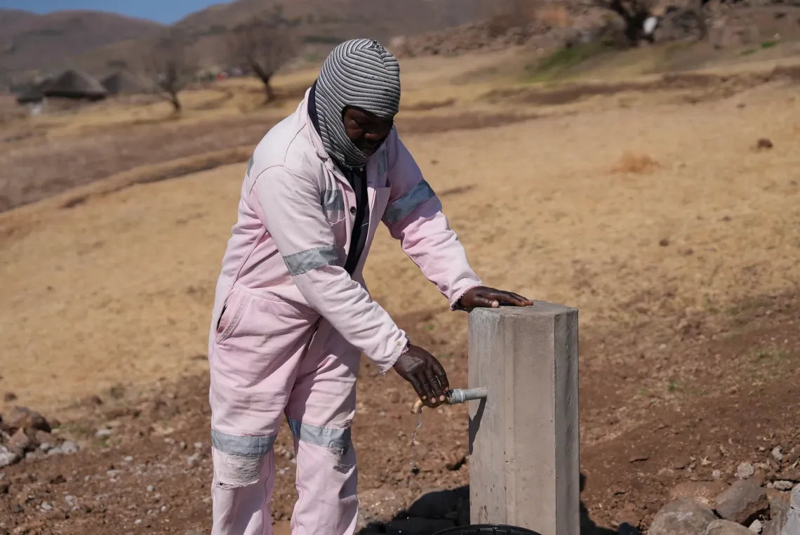 Area Chief of Ha-Mohloli near a newsly installed water tap.
