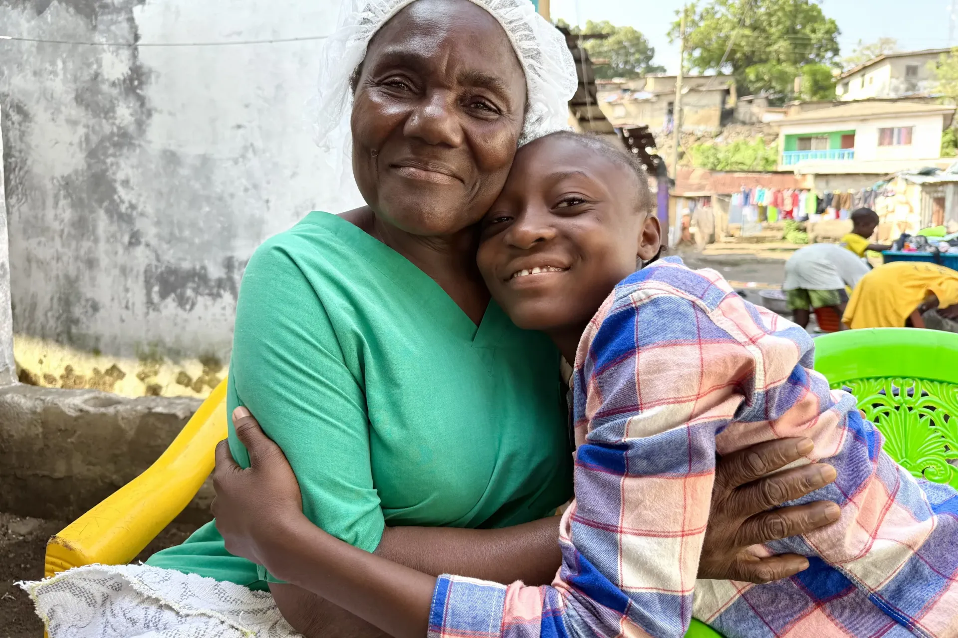 Anna and her fourteen-year-old granddaughter Esther, at their home in the Slipway Community affectionately embrace on January 9, 2026. 