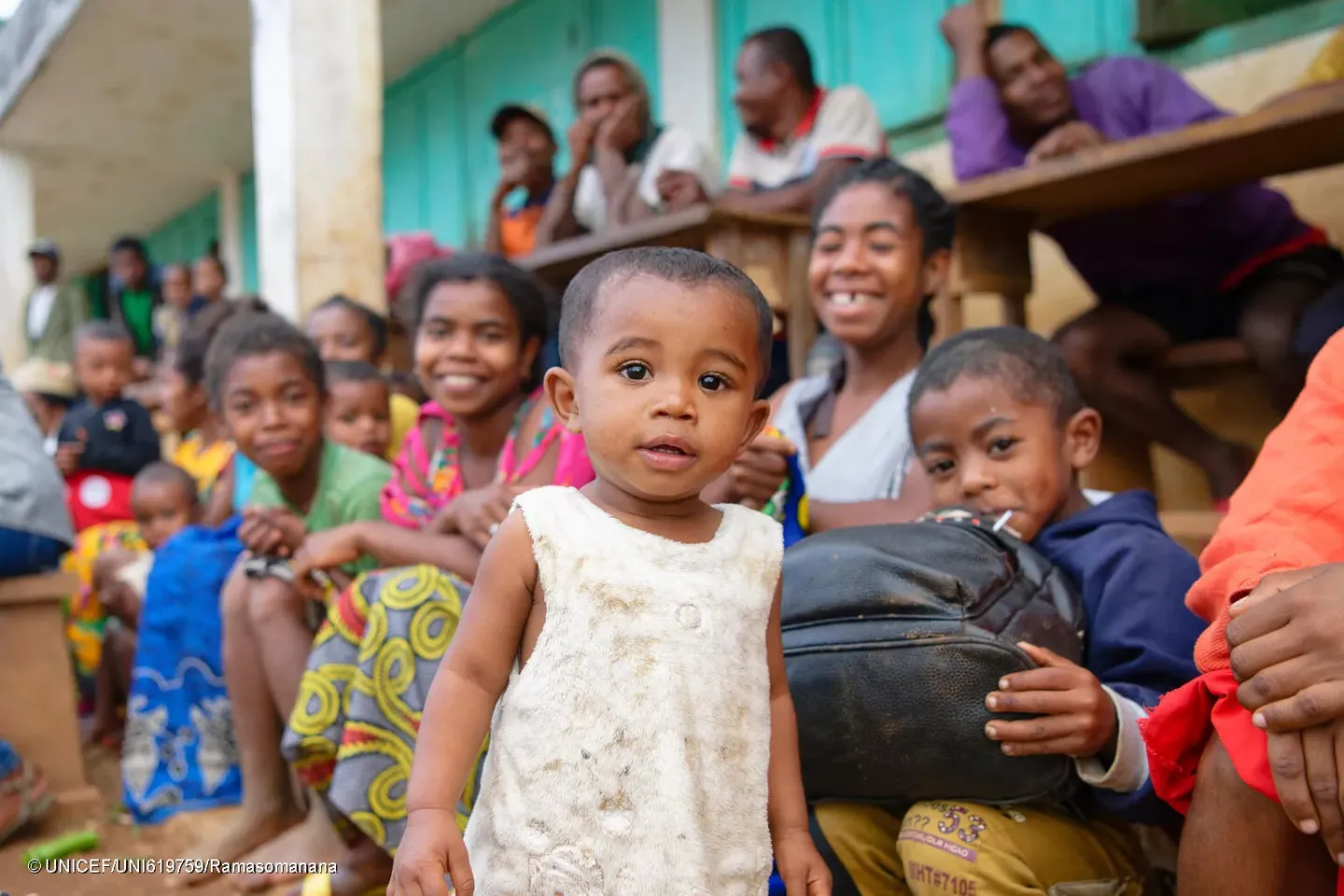 Commune of Mangatsiotra, Manakara District, Fitovinany Region, Madagascar: portrait of a child looking surprised standing among his loved ones