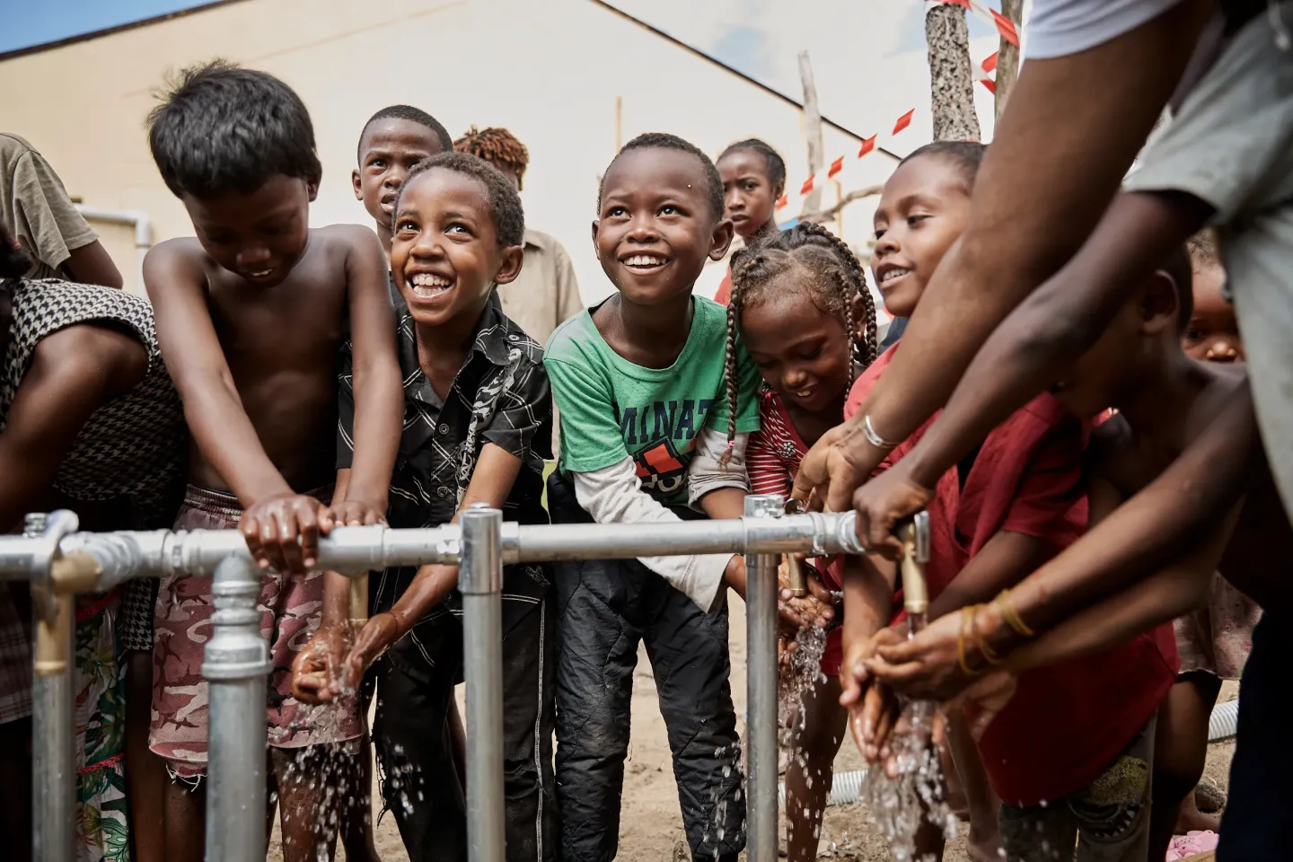 February 2026, Toamasina, east coast of Madagascar. During emergency operations, children gather at a UNICEF-installed water point, where rapid support helped restore access to safe water in the aftermath of Cyclone Gezani.                                 