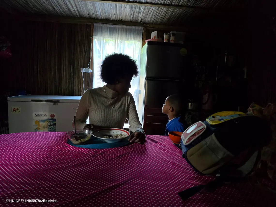 Casmira and her brother taking breakfast at home.