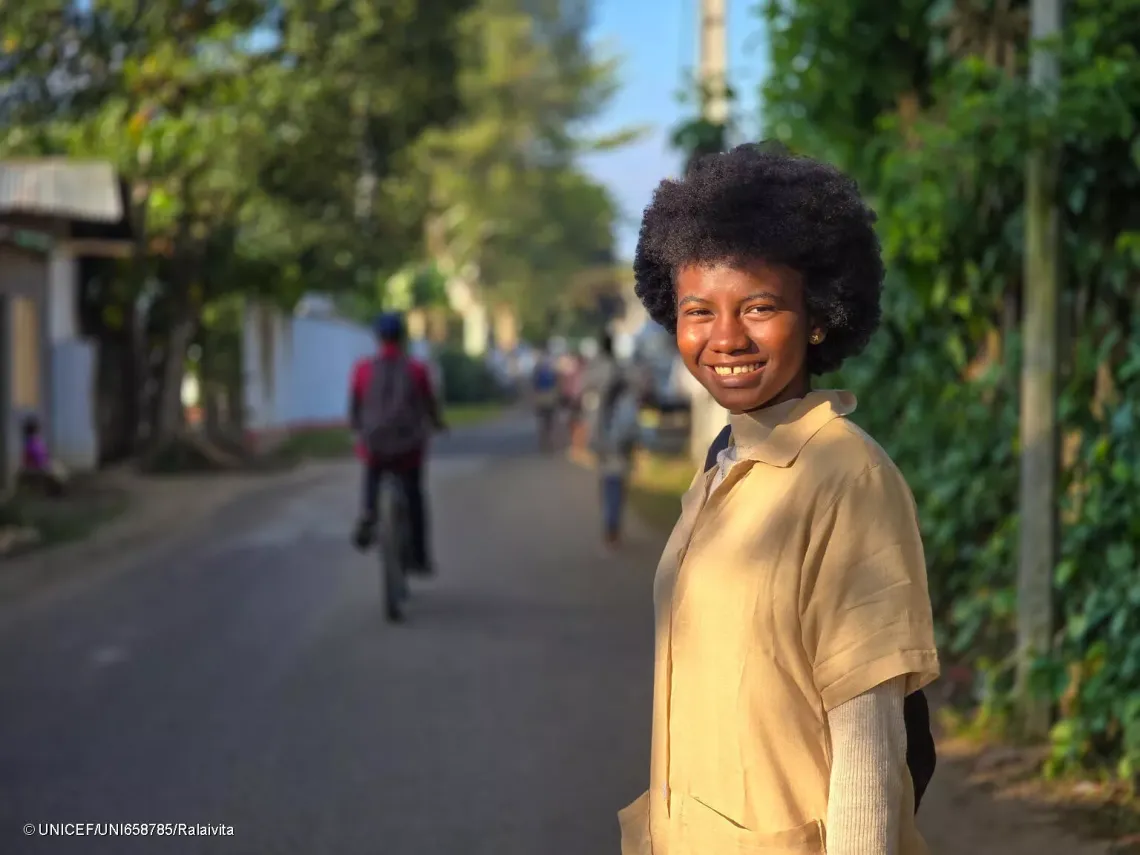 portrait photo of Casmira on the road to school the morning.