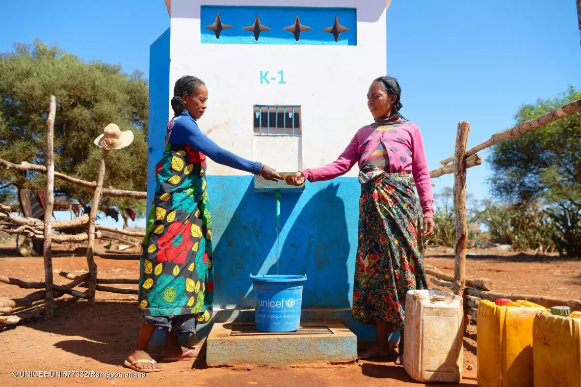 October 17, 2024 - Koronga Centre, Commune of Ambatotsivala, Beloha District, Androy Region, Madagascar : Mrs Lianasoa, 40, giving 100 Ariary to the pump manager for a bucket of water.