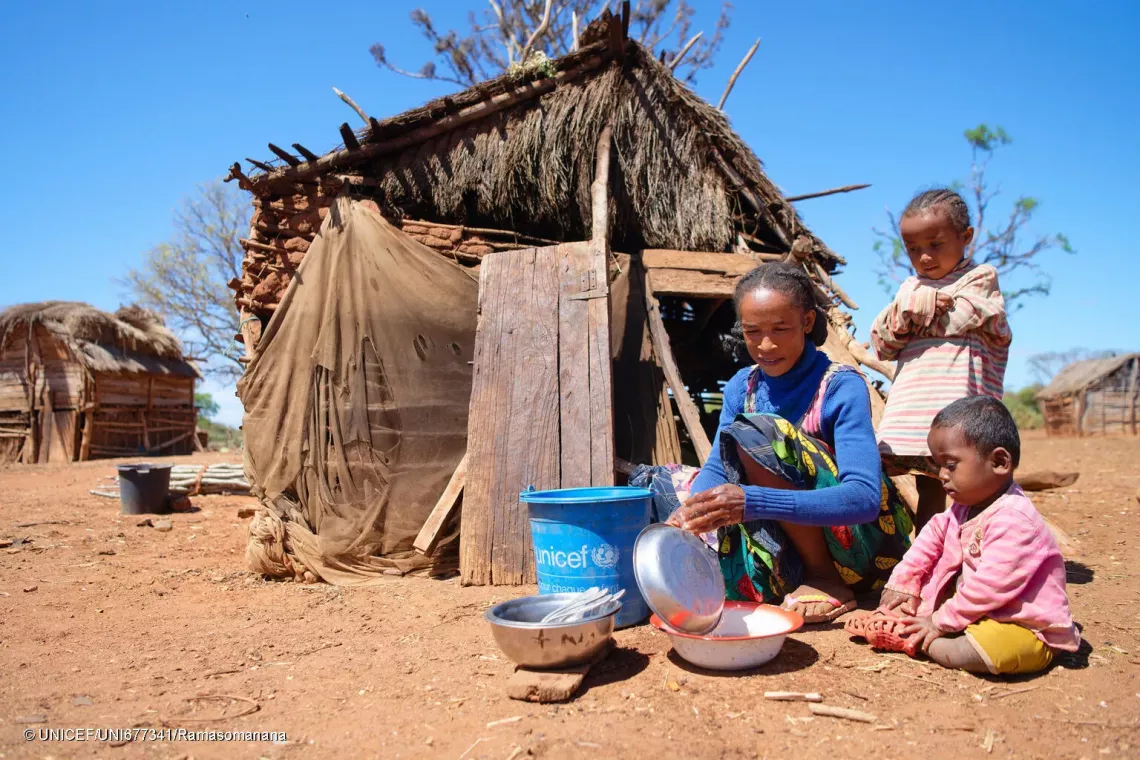 October 17, 2024 - Koronga Centre, Commune of Ambatotsivala, Beloha District, Androy Region, Madagascar : Mrs Lianasoa, 40, washing dishes outside her kitchen with her daughter and one of her daughter's son.