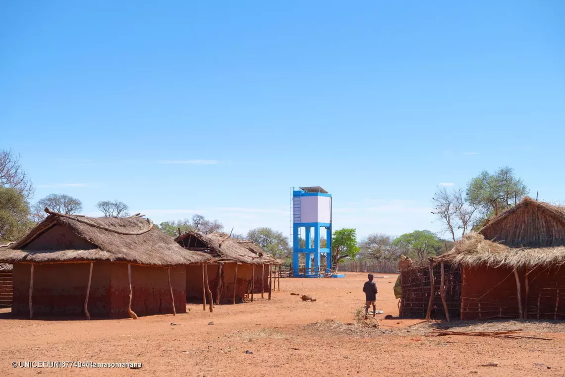 October 17, 2024 - Koronga Centre, Commune of Ambatotsivala, Beloha District, Androy Region, Madagascar : a young boy standing in the middle of the village with the water tower funded by the project on the background.