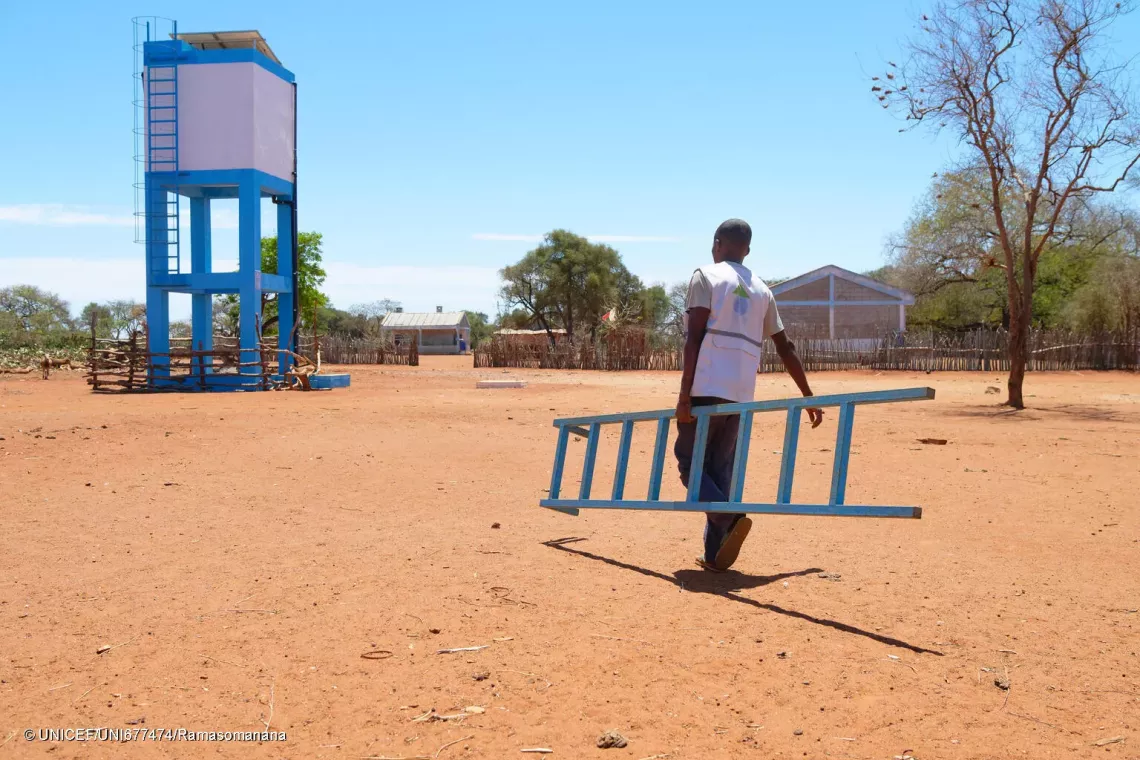 October 17, 2024 - Koronga Centre, Commune of Ambatotsivala, Beloha District, Androy Region, Madagascar : a technician from the Ny Ravo company, in charge of water management, carrying a ladder to access the water tower.