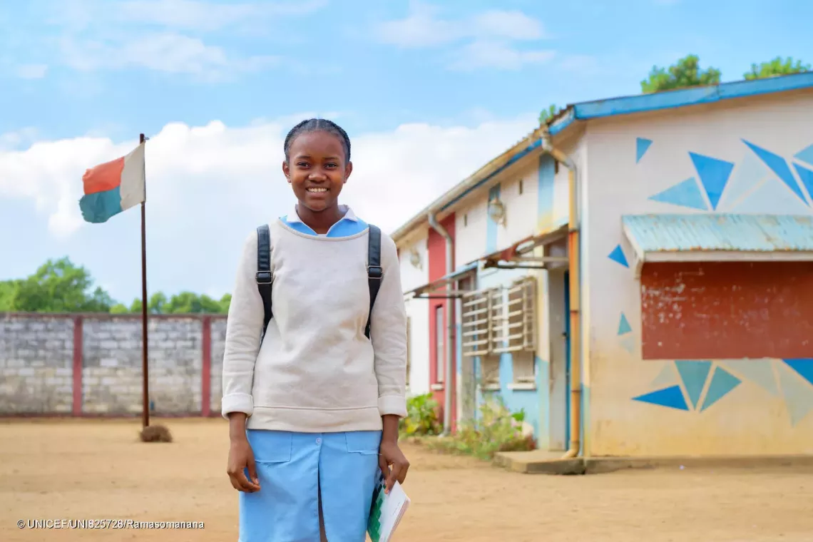portrait of Aim&eacute;lia smiling and standing in the schoollyard