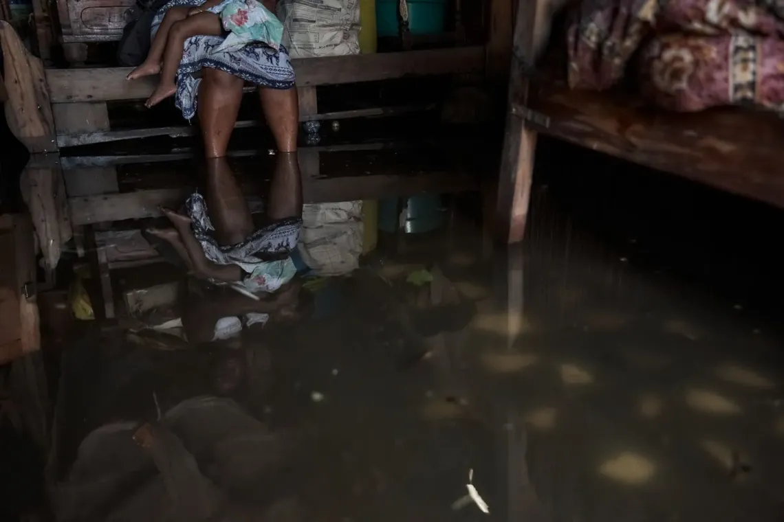Jean de Dieu, 13, observes the damage caused by Cyclone Gezani on the roof of one of the neighboring houses.