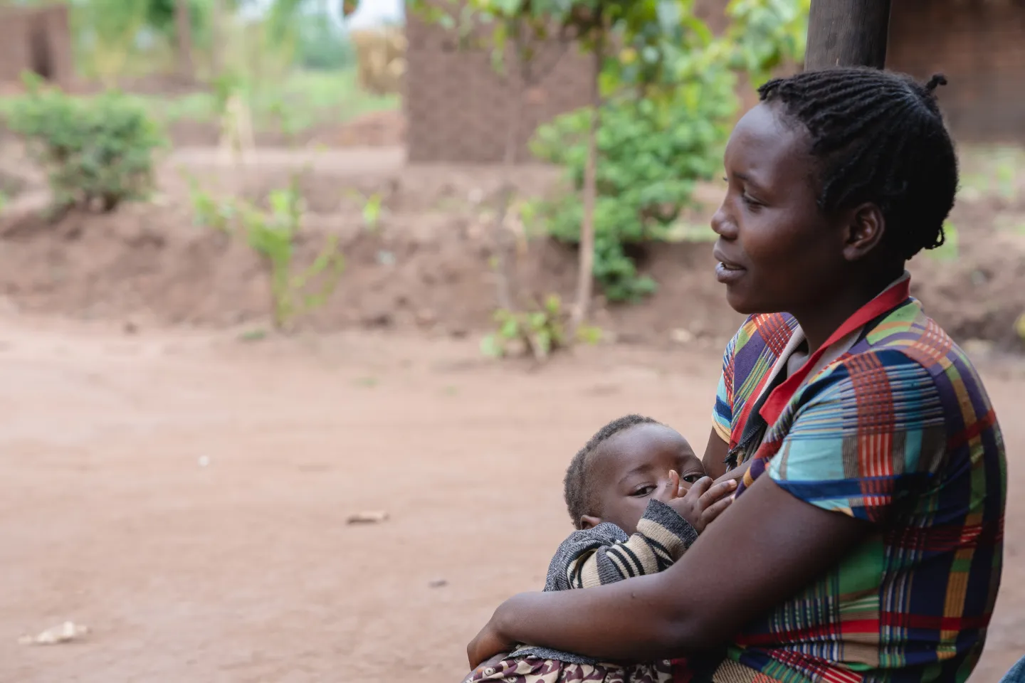 Violet Saulo breastfeeding her daughter (Margret) at her home in Mayelo Village, Mulanje