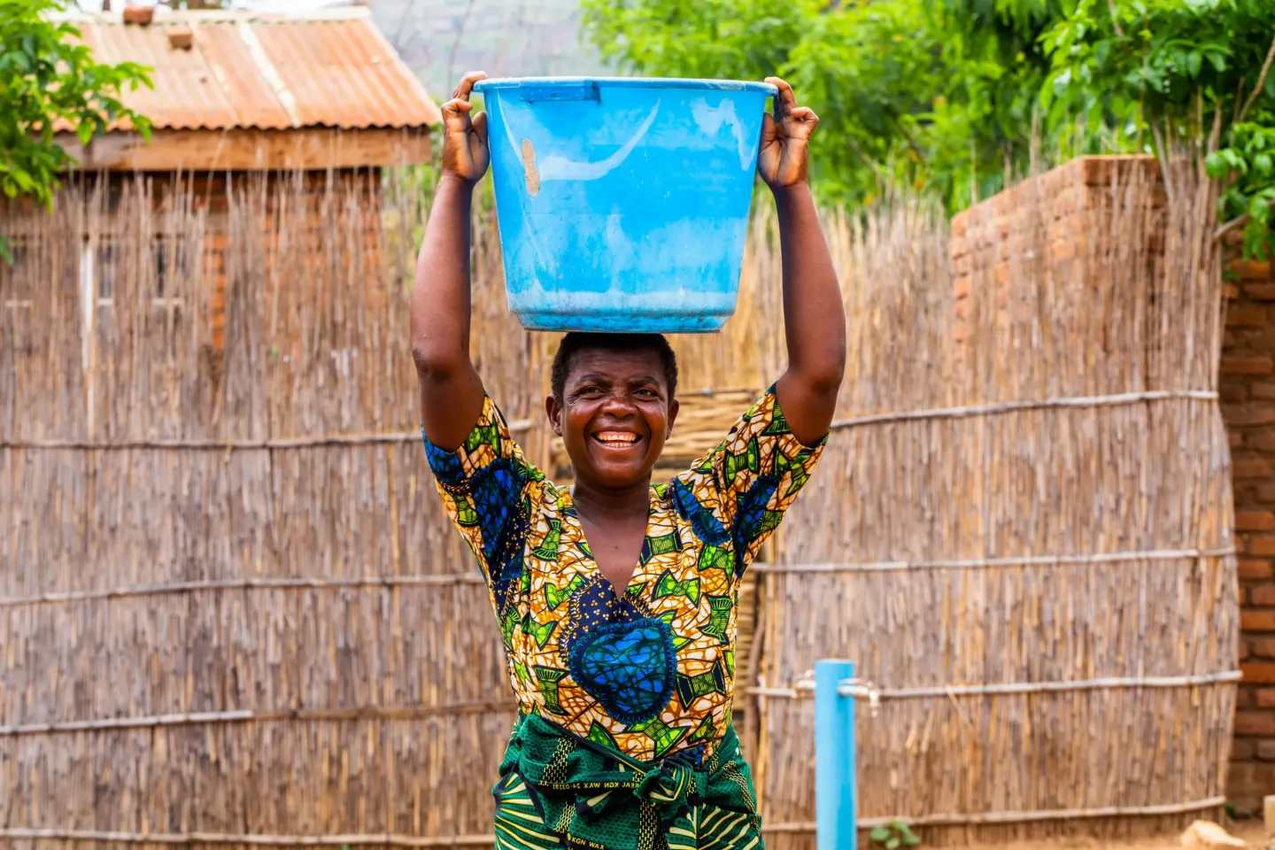 Joyce Robert after drawing water from the water scheme at Nalunga Health Centre in Dowa.