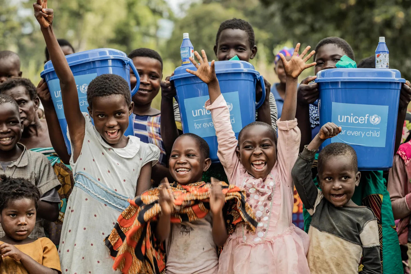 Children receive buckets donated by UNICEF