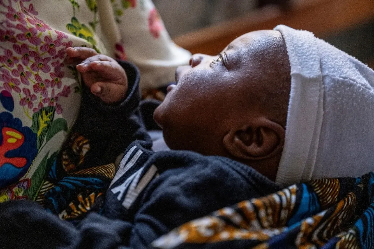 A baby stares at his mother