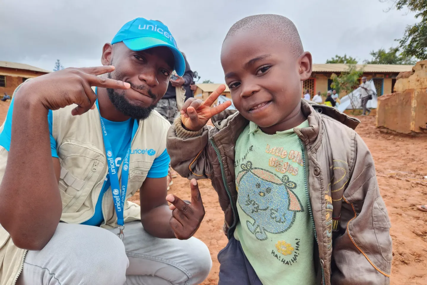 A UNICEF staff posing a photo with a child 