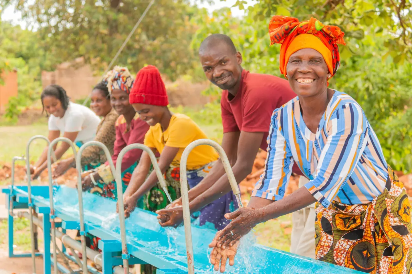 Members of the Tiyanjane Water Committee showcase the importance of handwashing at Chimatiro Health Centre in Balaka to promote hygiene 