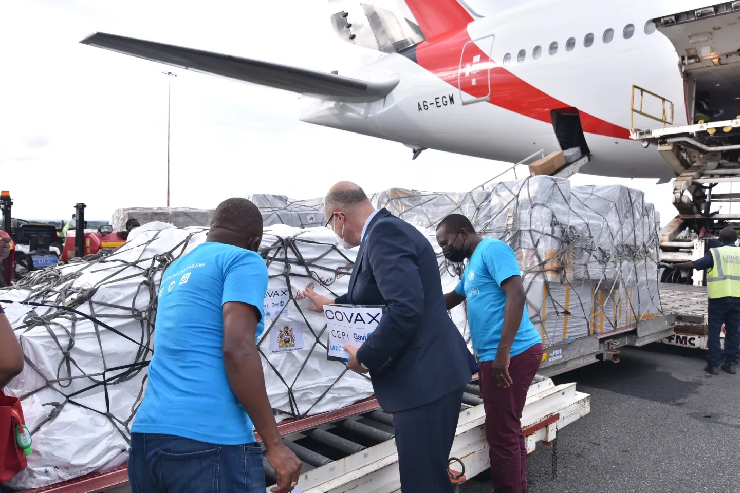 UNICEF staff inspecting the COVAX supplies at Kamuzu International Airport