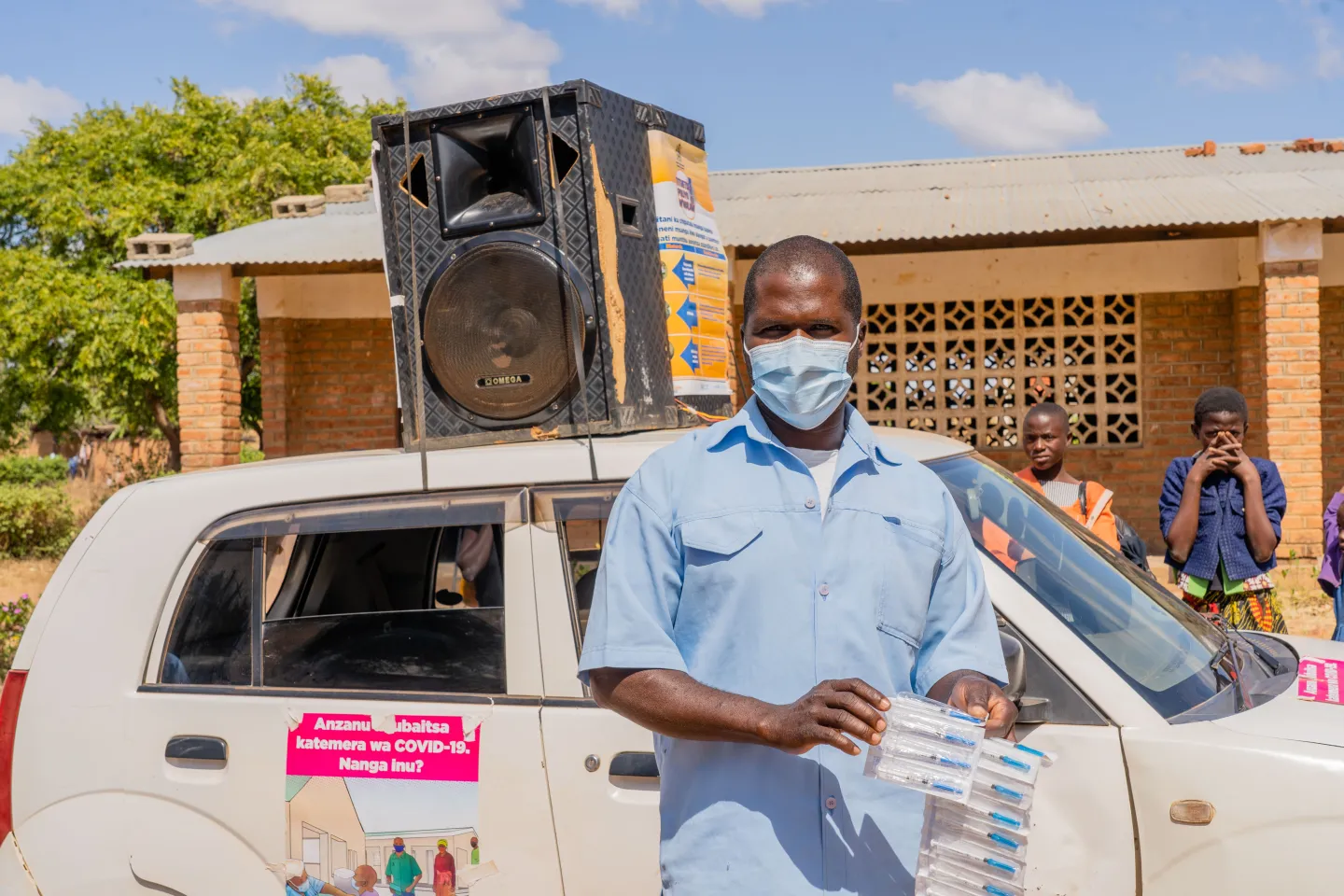 Mr Robert Moyo showing COVID-19 tests before he commences vaccination 