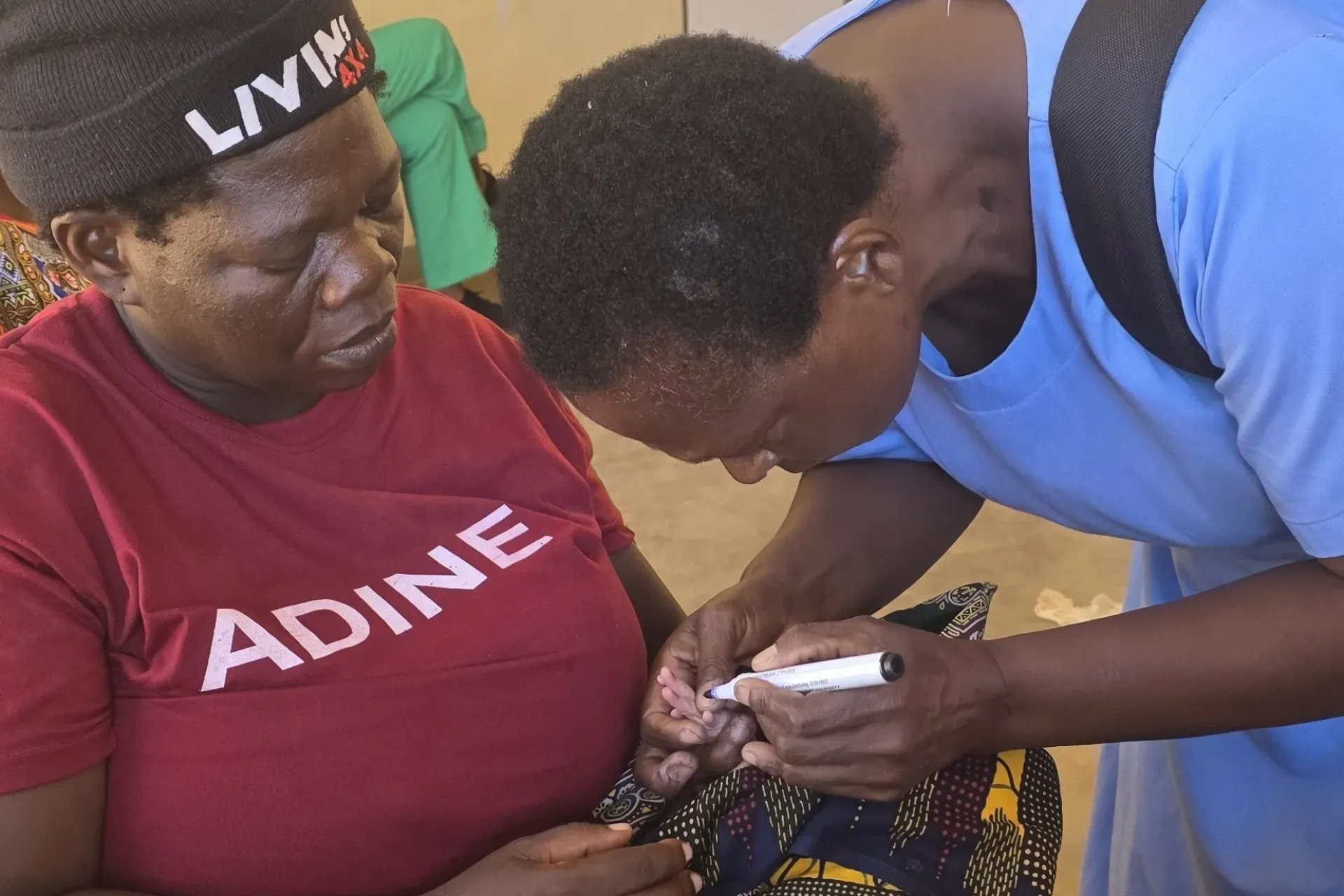 Rose Dinasi getting her newborn son finger-marked