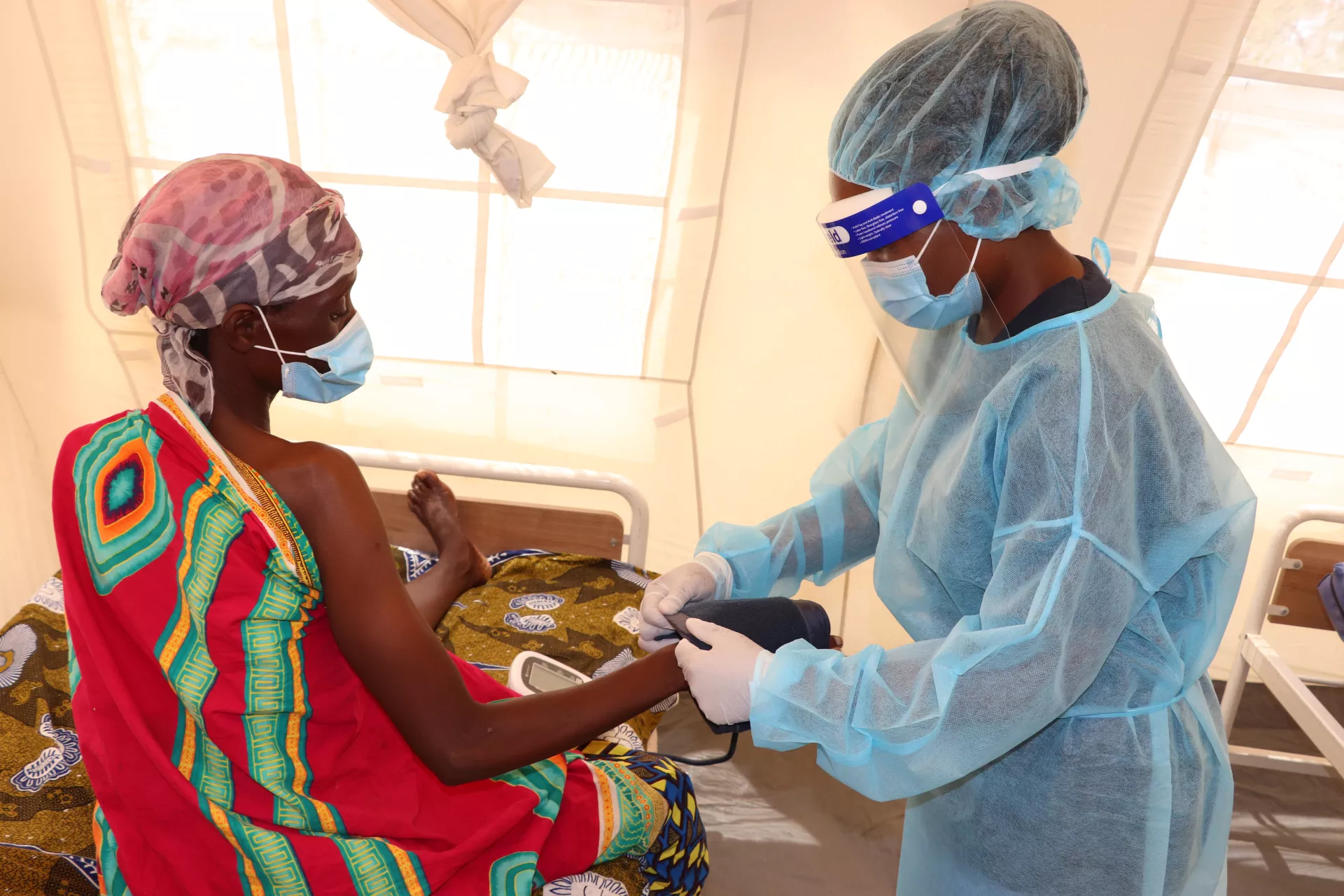 A health worker assists a COVID-19 patient at Mchinji Emergency Treatment Unit
