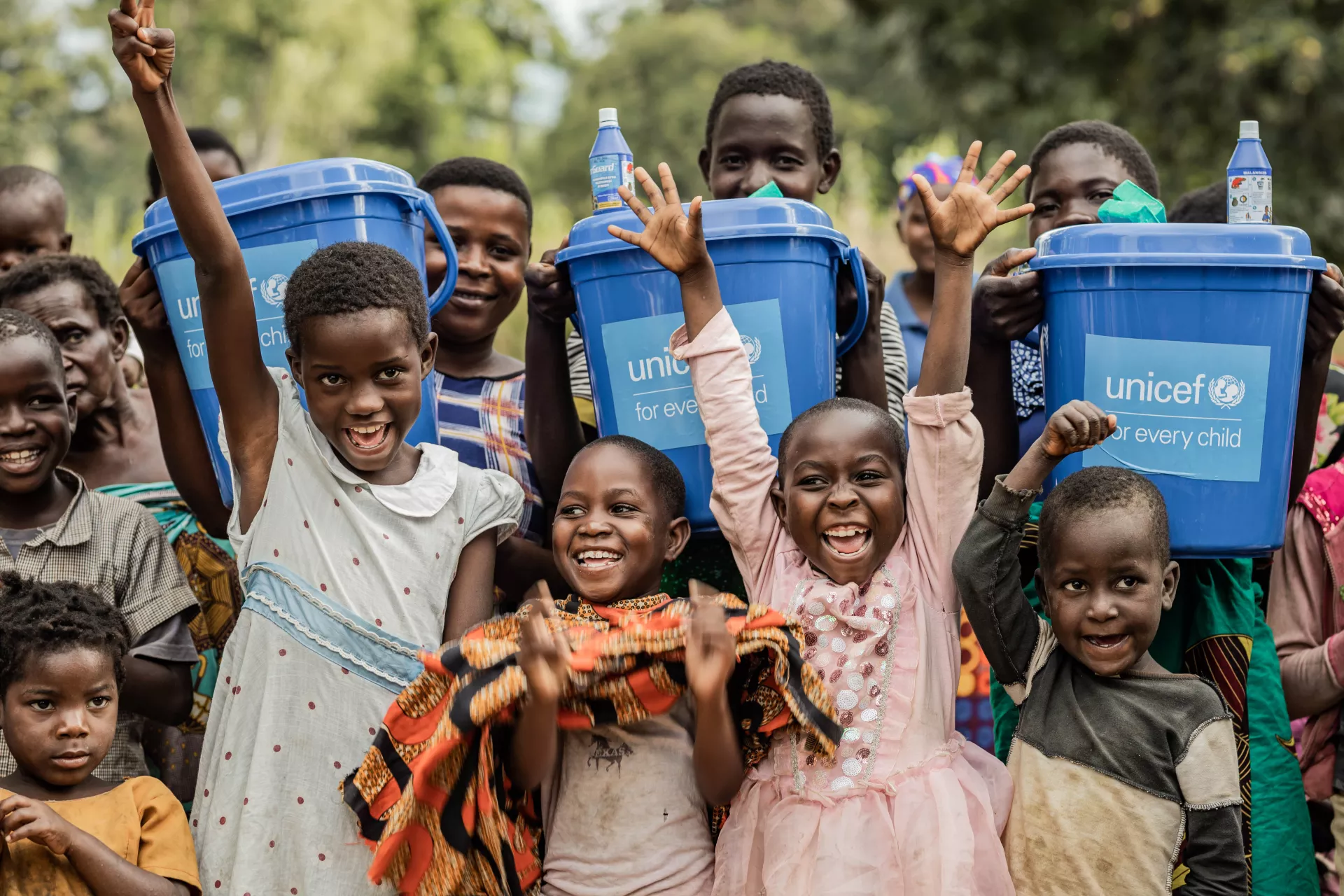 Children receive buckets donated by UNICEF