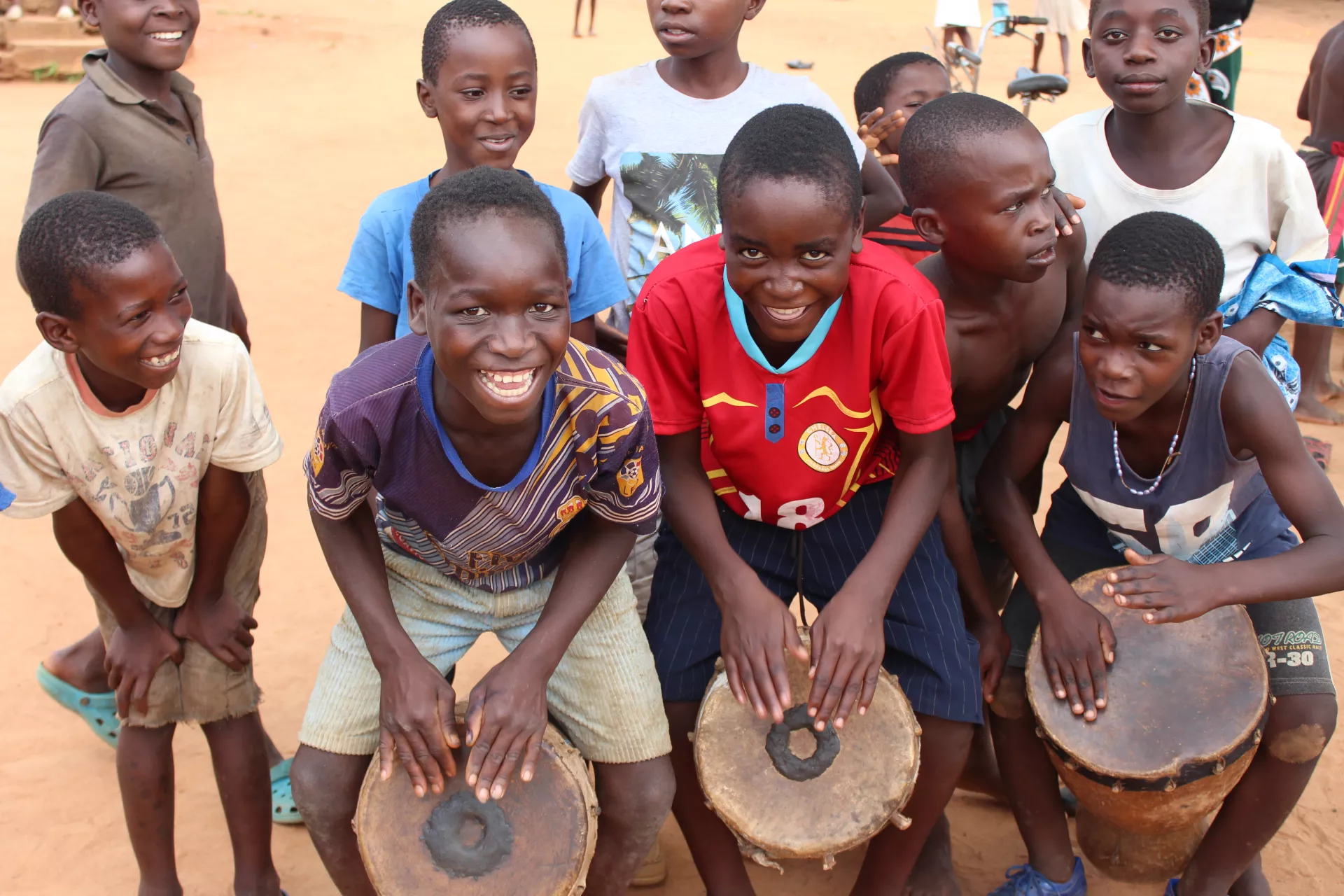 Children playing with drums at Jombo Children's Corner