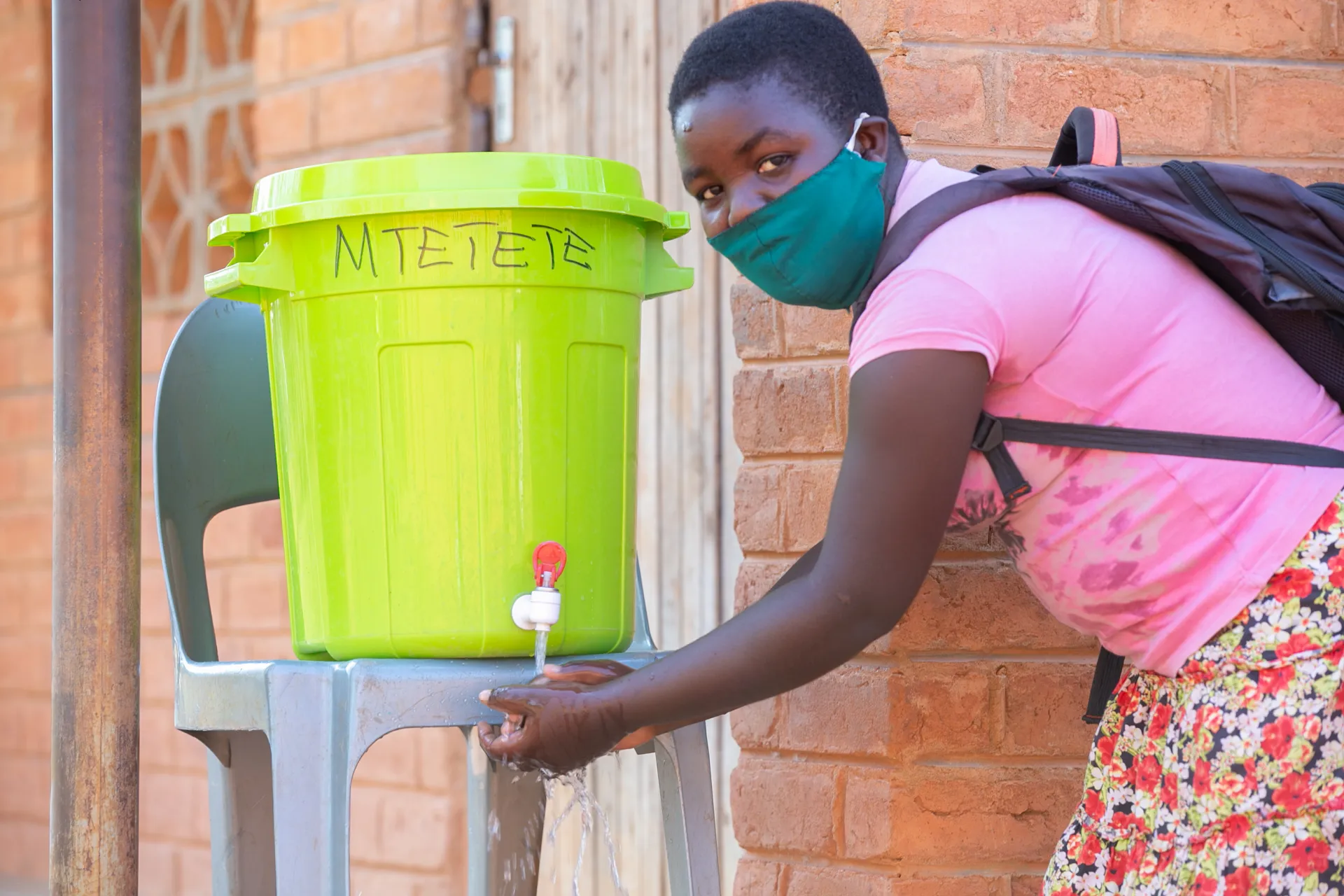 A student washing hands at Mtetete primary school in Nkhatabay